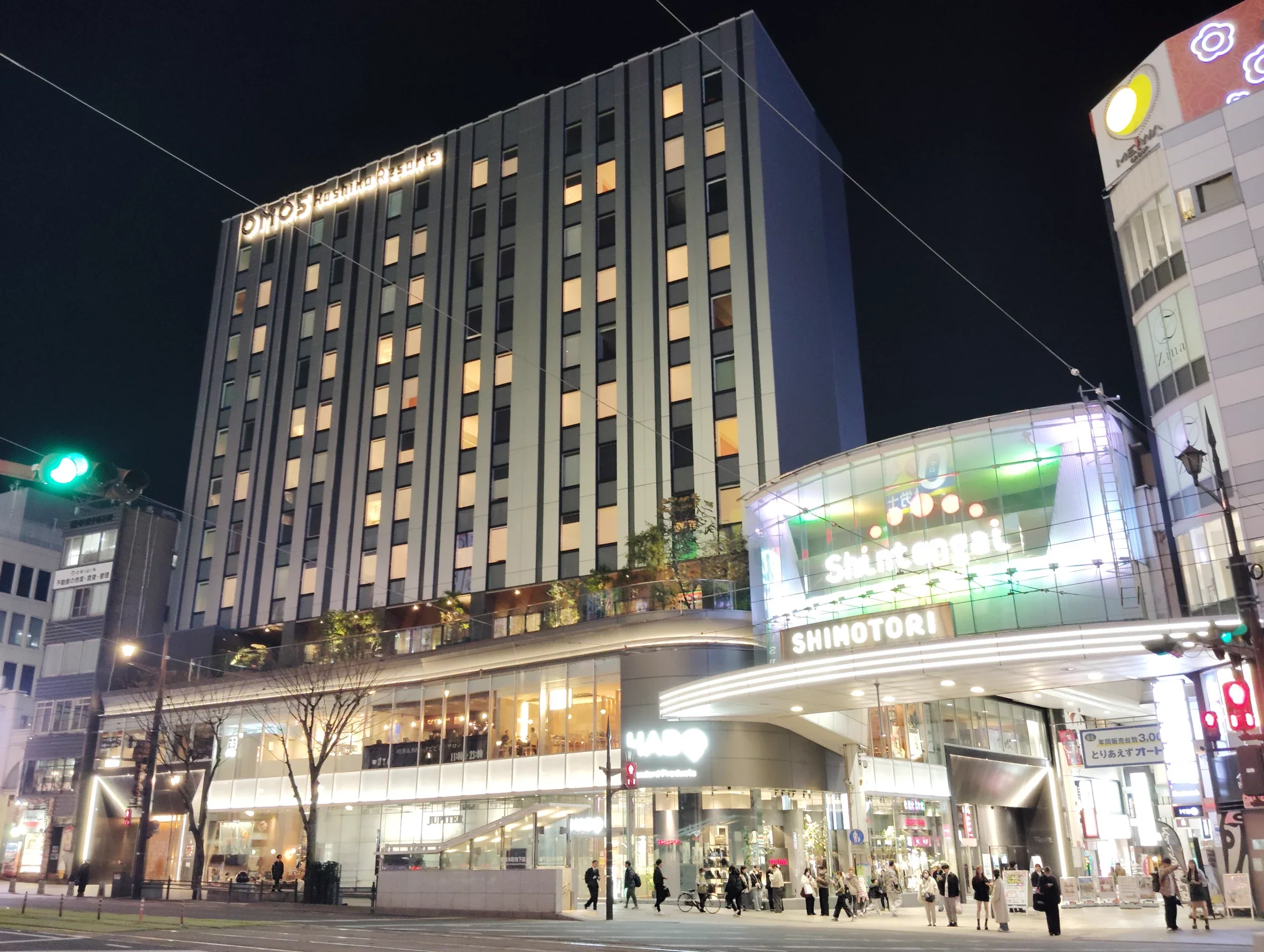 夜間的 OMO5 熊本所在大樓與下通街口，樓頂可見飯店標誌